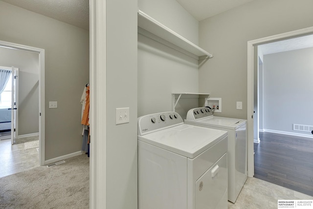 laundry area with separate washer and dryer, laundry area, baseboards, and visible vents