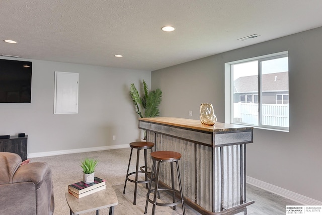 bar with recessed lighting, baseboards, and visible vents