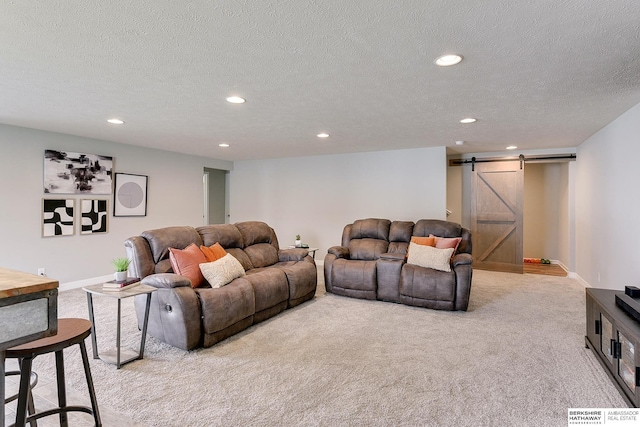 carpeted living area with baseboards, recessed lighting, and a barn door
