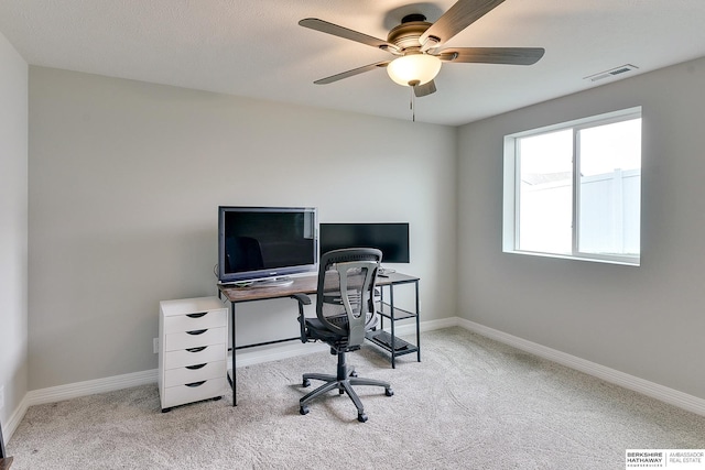 home office featuring carpet flooring, ceiling fan, visible vents, and baseboards