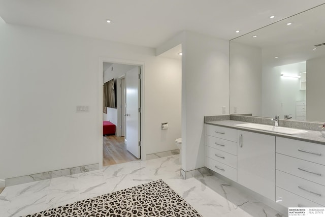 ensuite bathroom featuring visible vents, vanity, marble finish floor, toilet, and recessed lighting
