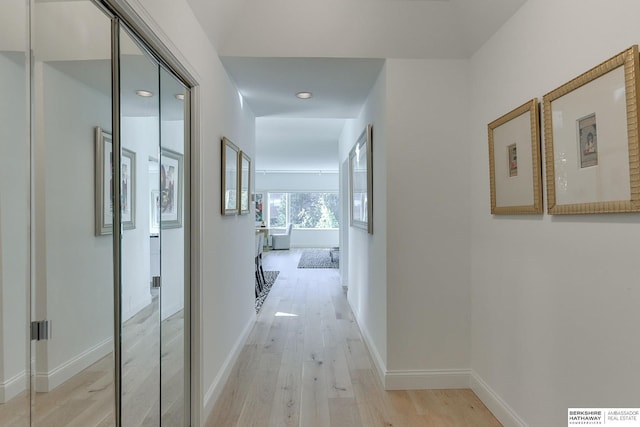 hallway featuring visible vents, recessed lighting, light wood-style flooring, and baseboards