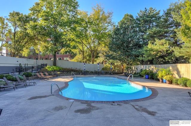 pool featuring a patio area and fence