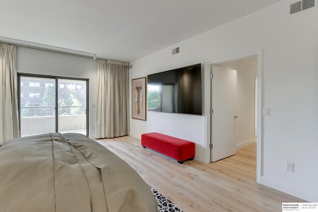 bedroom featuring access to outside, baseboards, visible vents, and wood finished floors