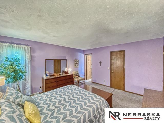 carpeted bedroom featuring a textured ceiling