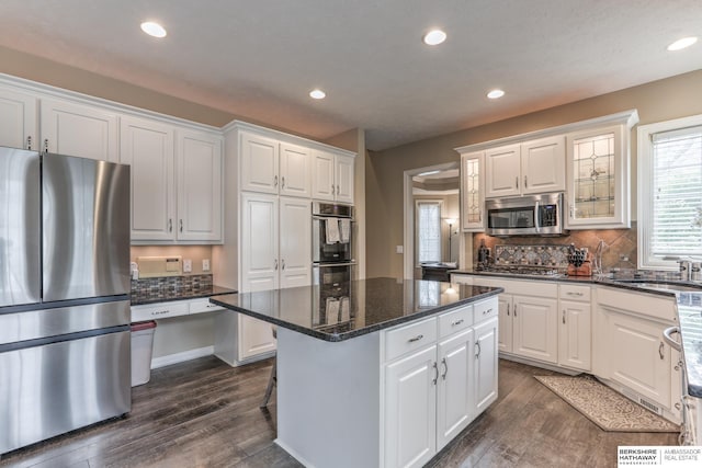 kitchen featuring appliances with stainless steel finishes, white cabinets, and dark wood-style floors