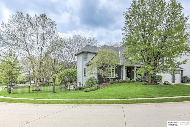view of front of property with fence, driveway, a front yard, and a garage