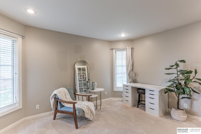 sitting room featuring recessed lighting, baseboards, and light carpet