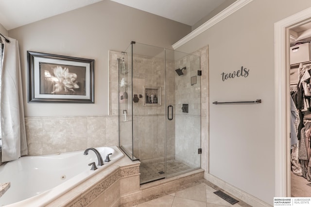 bathroom with visible vents, a bath, a spacious closet, tile patterned floors, and a stall shower