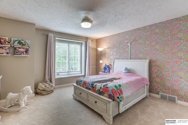 bedroom featuring visible vents, baseboards, and light carpet