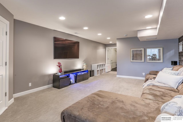 carpeted living area featuring baseboards and recessed lighting