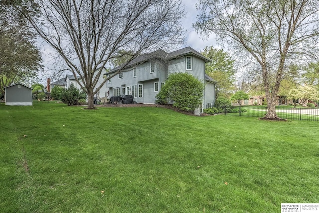 view of yard featuring fence and an outdoor structure