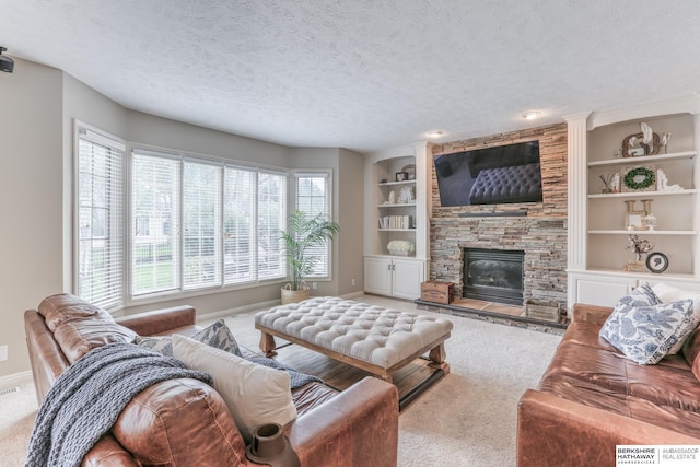 carpeted living area featuring a stone fireplace, a textured ceiling, baseboards, and built in shelves