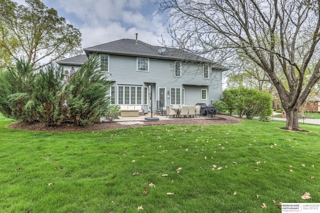 rear view of property with roof with shingles, entry steps, a yard, and a patio area