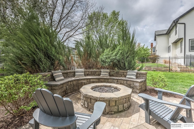 view of patio / terrace with fence and a fire pit
