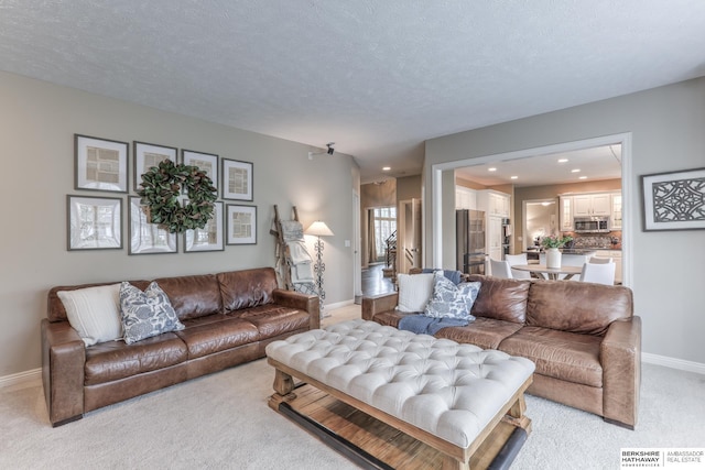 living room featuring recessed lighting, baseboards, light colored carpet, and a textured ceiling