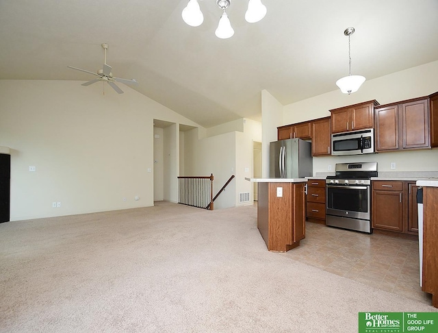 kitchen with stainless steel appliances, open floor plan, light colored carpet, and lofted ceiling