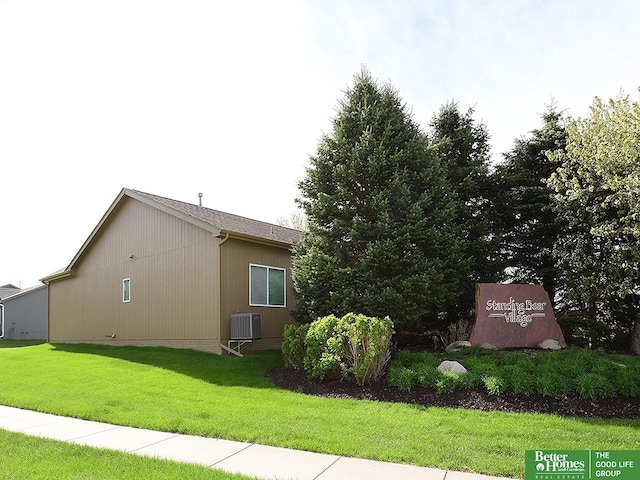 view of home's exterior featuring a lawn and cooling unit