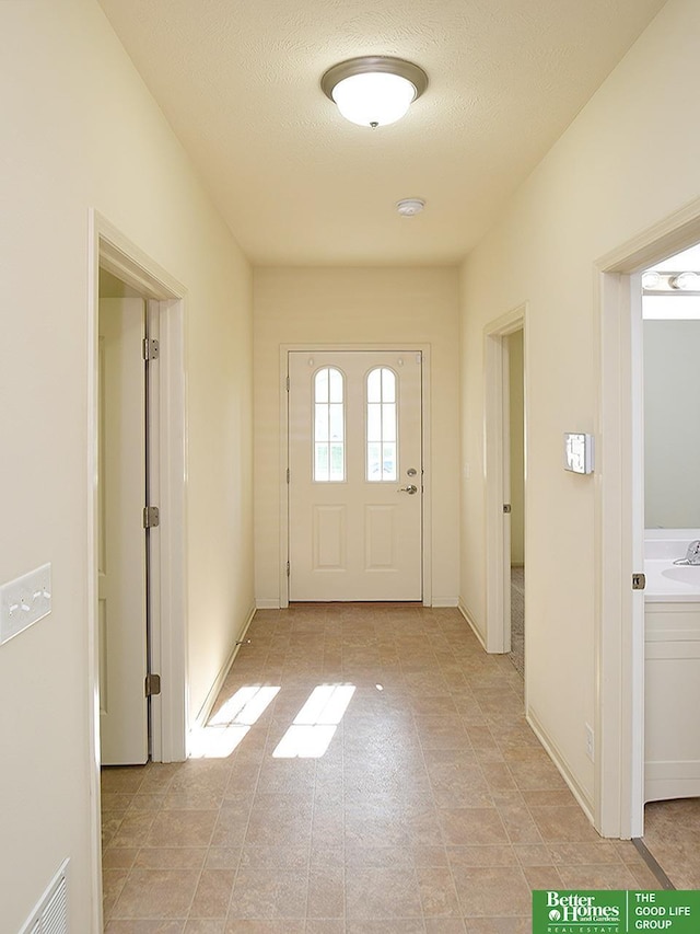 doorway with visible vents and a sink