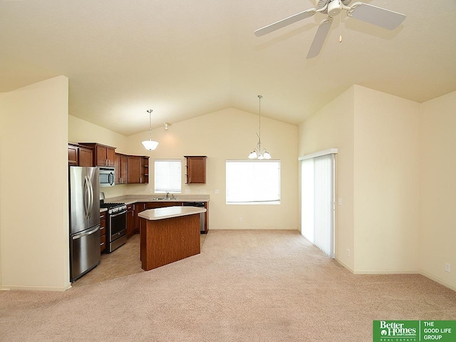 kitchen with plenty of natural light, a sink, appliances with stainless steel finishes, and a center island