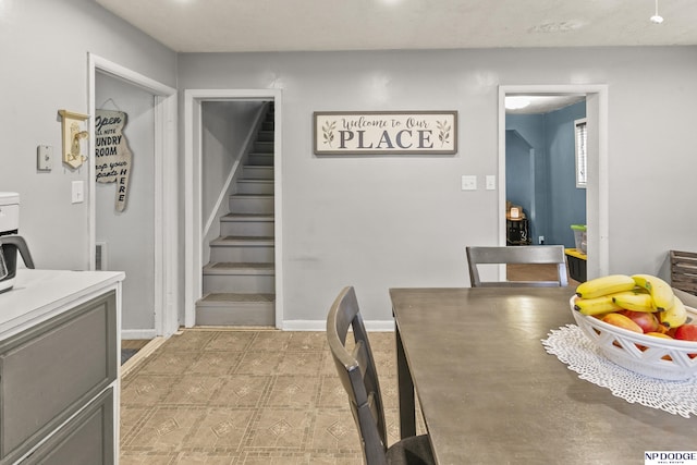 dining space with stairs and baseboards