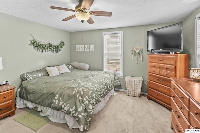 bedroom with a ceiling fan and light carpet