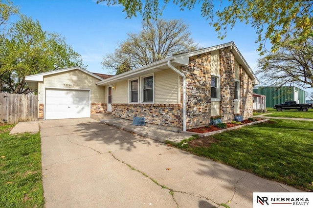 view of front of home with a garage, fence, a front yard, brick siding, and concrete driveway