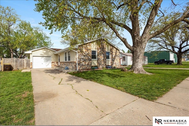 ranch-style home with concrete driveway, an attached garage, fence, and a front lawn