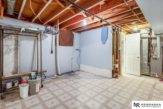 unfinished basement with heating unit and tile patterned floors