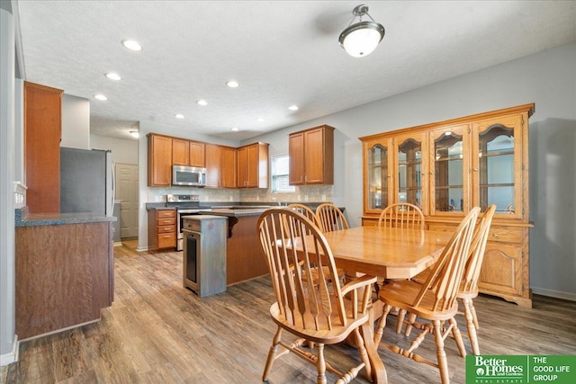 7714 S 167th St, Omaha, NE 68136 - dining area featuring recessed lighting, baseboards, and wood finished floors