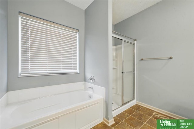 7714 S 167th St, Omaha, NE 68136 - bathroom featuring baseboards, tile patterned floors, a bath, and a shower stall