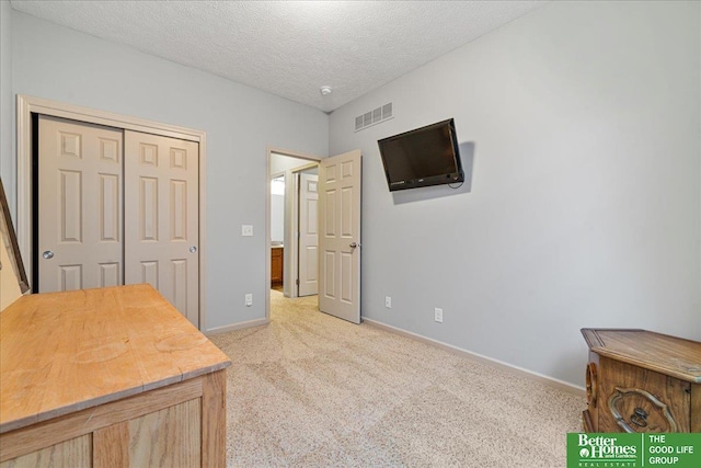 7714 S 167th St, Omaha, NE 68136 - bedroom featuring visible vents, a closet, light carpet, baseboards, and a textured ceiling