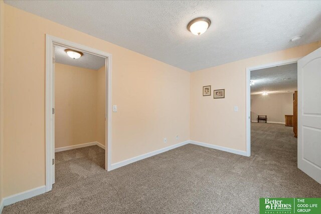 7714 S 167th St, Omaha, NE 68136 - carpeted spare room with baseboards and a textured ceiling