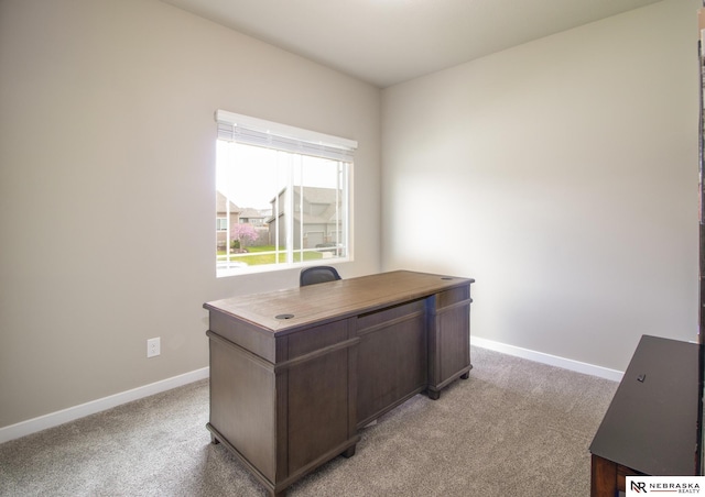 office space featuring light colored carpet and baseboards