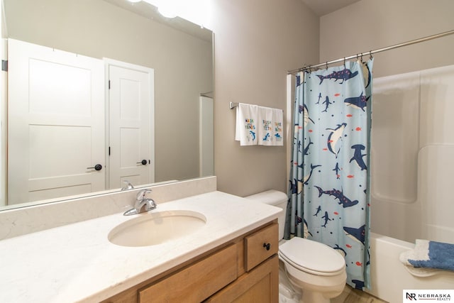bathroom with vanity, shower / bath combination with curtain, and toilet
