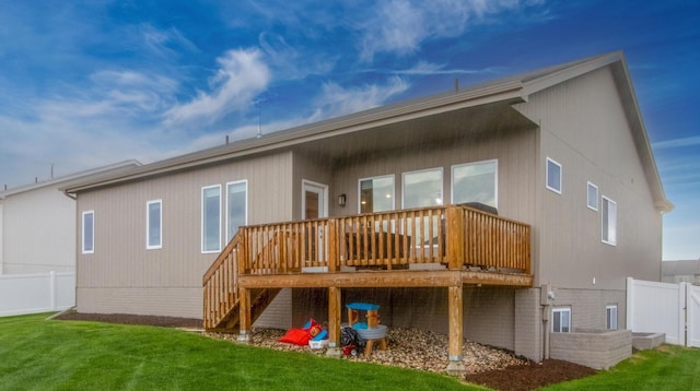 back of house featuring a lawn, fence, and a deck