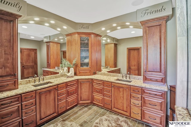 full bathroom with a sink, ornate columns, and recessed lighting