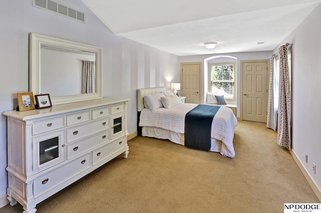 bedroom featuring vaulted ceiling, baseboards, light colored carpet, and visible vents