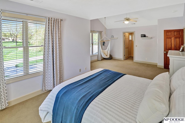 bedroom featuring visible vents, light carpet, baseboards, ceiling fan, and vaulted ceiling