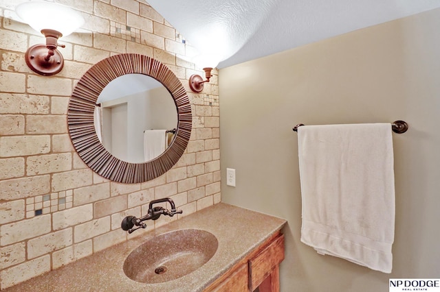 bathroom featuring vanity and tasteful backsplash