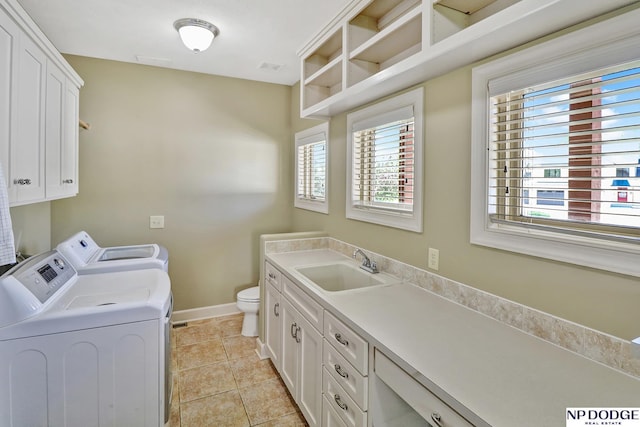 laundry room with laundry area, a sink, independent washer and dryer, and a wealth of natural light