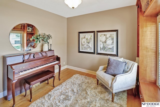living area featuring baseboards and wood finished floors