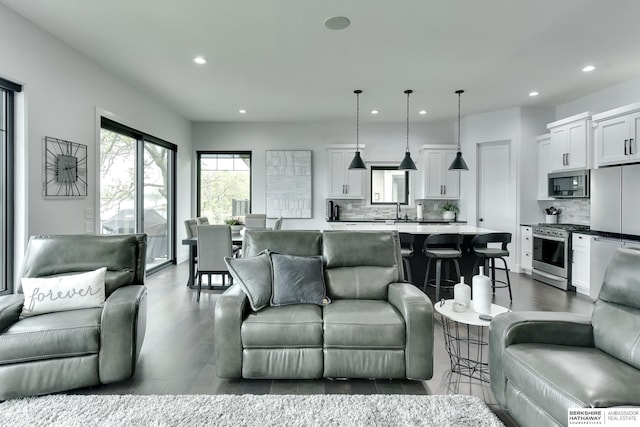 living room with recessed lighting and dark wood finished floors