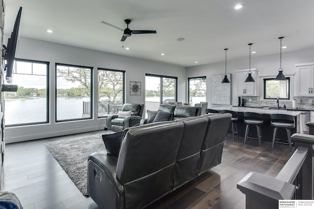 living area featuring a ceiling fan, recessed lighting, and dark wood-style floors