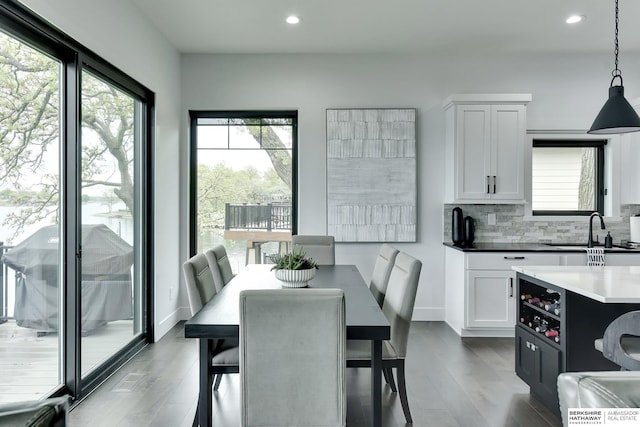 dining room featuring plenty of natural light, recessed lighting, and wood finished floors