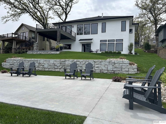 back of property with a patio and a yard