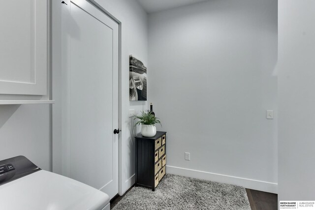laundry room with baseboards and carpet flooring