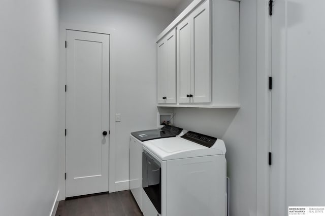 washroom featuring baseboards, dark wood-style floors, cabinet space, and washing machine and clothes dryer