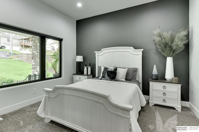 carpeted bedroom featuring baseboards