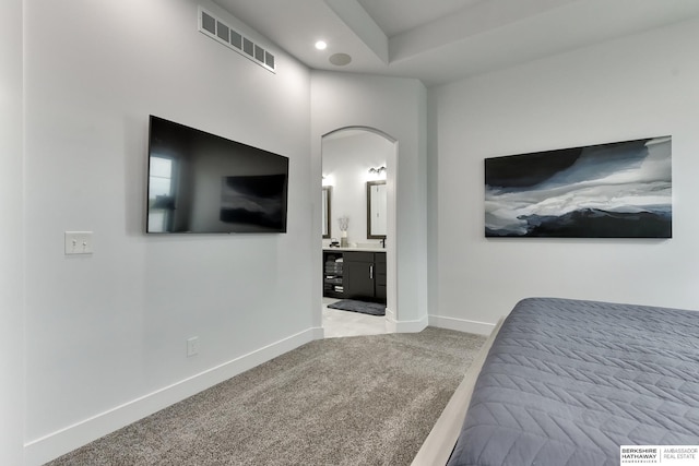 bedroom featuring visible vents, arched walkways, baseboards, carpet, and recessed lighting